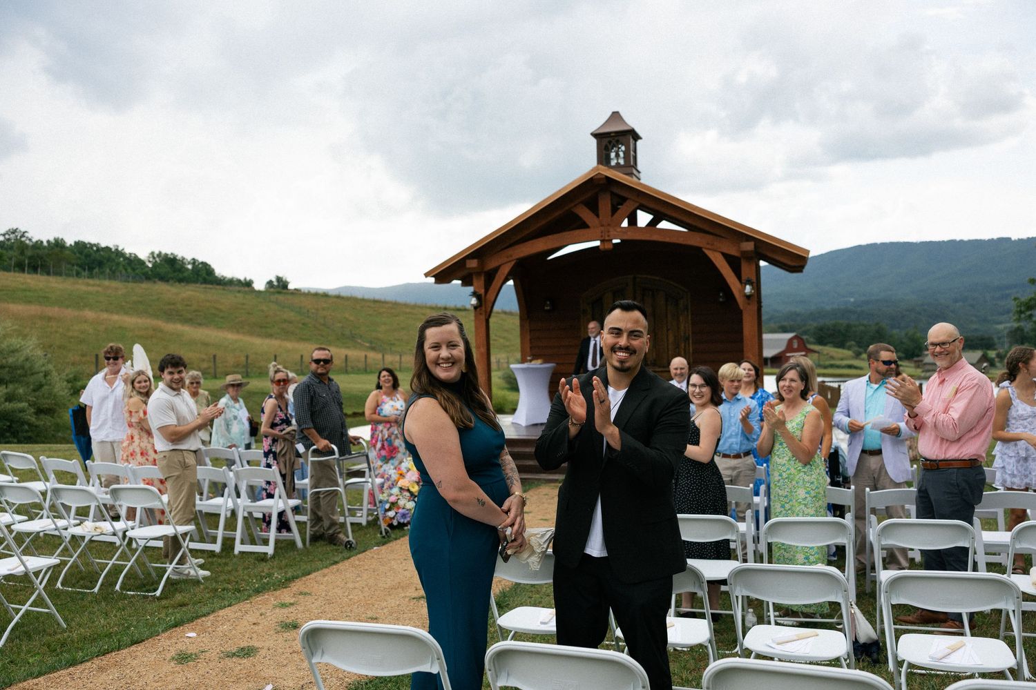 Wooden wedding pavilion and white chairs set up in a scenic mountain meadow.Micro wedding, elopement, intentional celebration