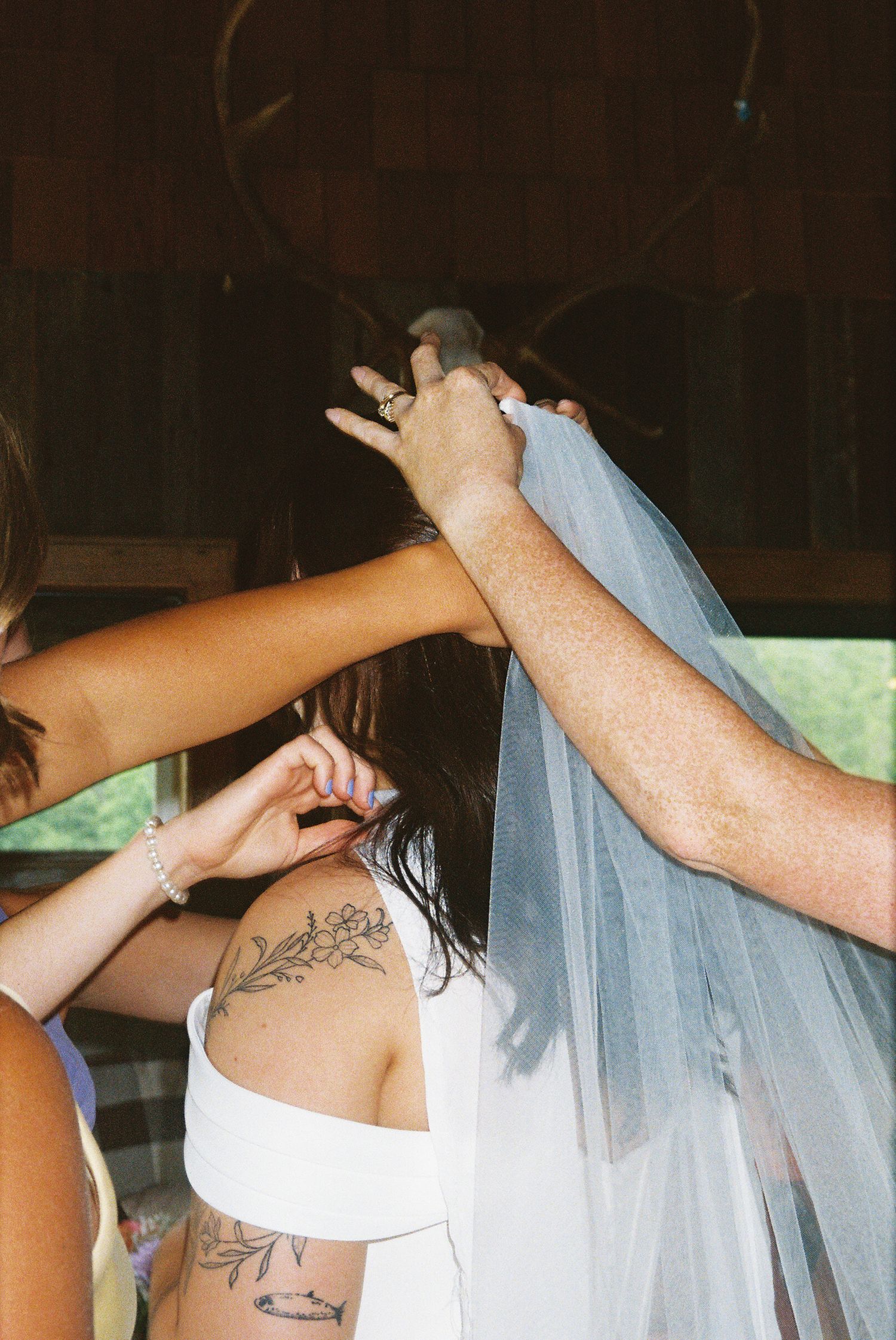 A sequence of images showing a bride's veil being adjusted and arranged during wedding preparations.Micro wedding, elopement, intentional ce