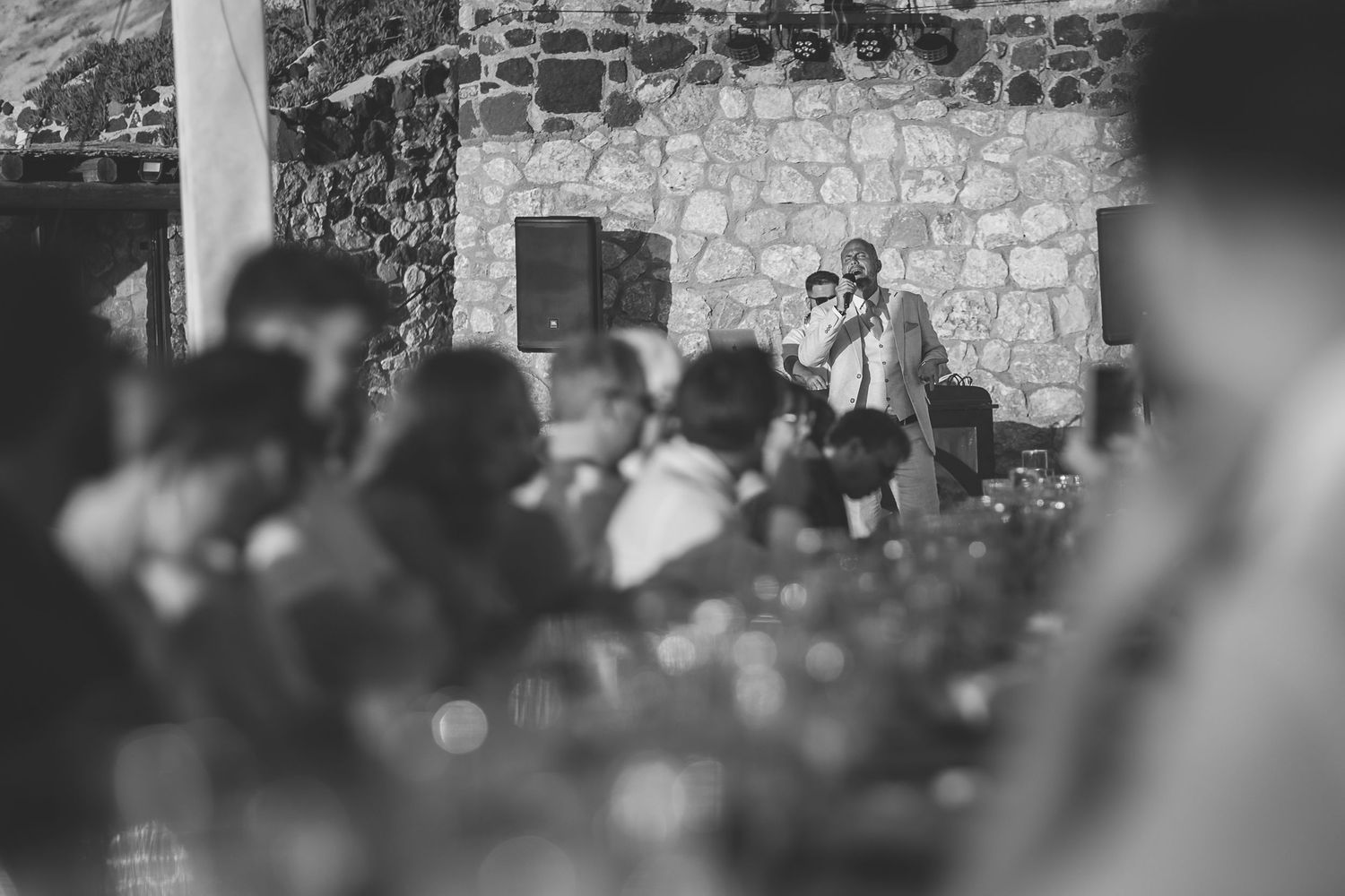 Black and white photograph of a wedding singer at El Viento Santorini Destination wedding venue.