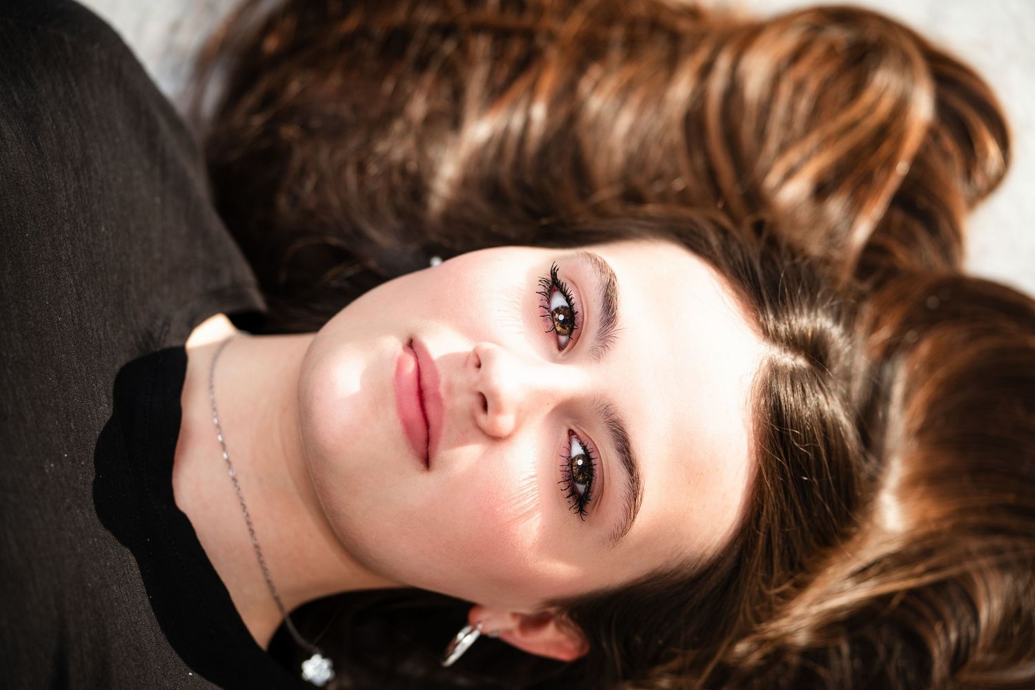 A series of close-up portrait shots showing different angles and expressions with dramatic lighting and makeup.
