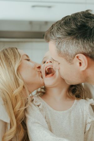 A romantic sequence of four photos showing intimate moments and tender kisses between a couple in soft, natural lighting.