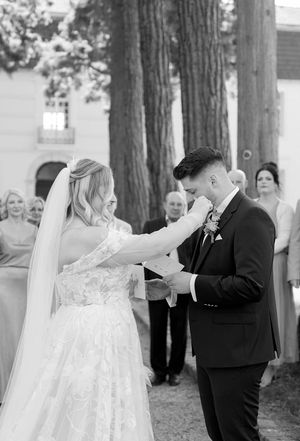 The bride and groom share an intimate moment during their outdoor wedding ceremony.