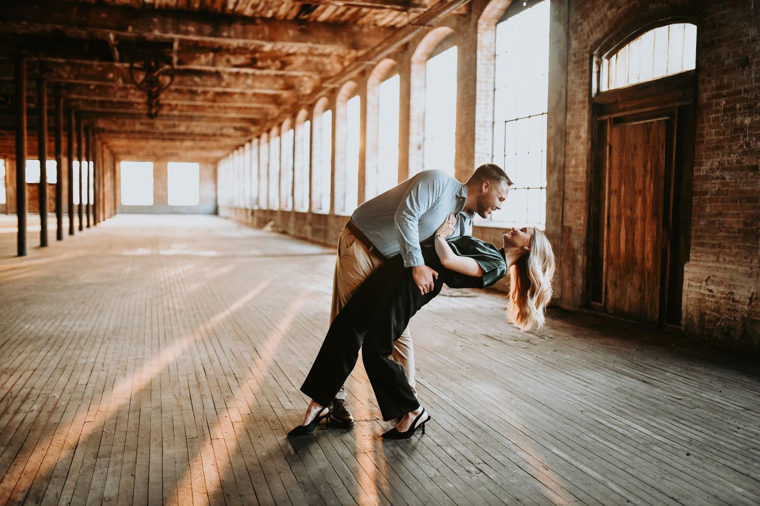 Romantic engagement photo at Cotton Mill McKinney with warm golden light