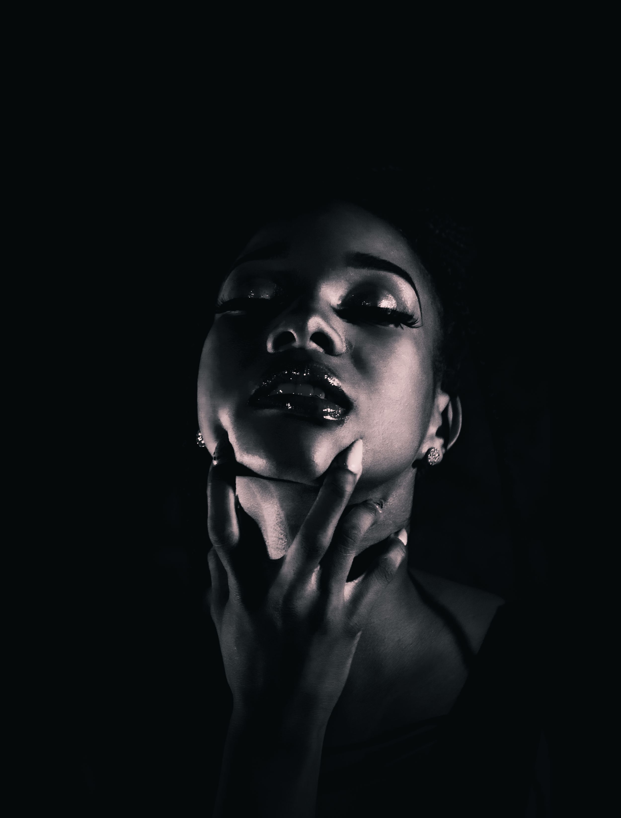 Dramatic black and white portrait sequence showing hands covering face in shadow.