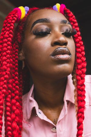 Close-up beauty portraits featuring bright red braids and natural makeup.