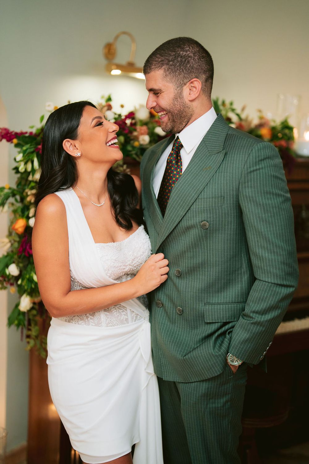 A couple shares intimate moments in a sequence of wedding photos showing loving poses against floral decor.