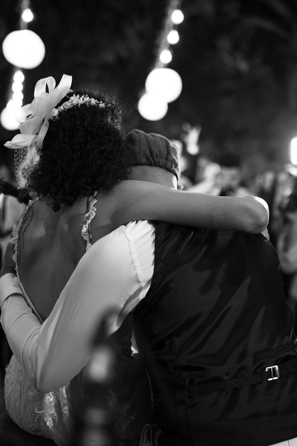 A romantic black and white photo sequence shows a couple dancing and sharing an intimate moment under twinkling lights.