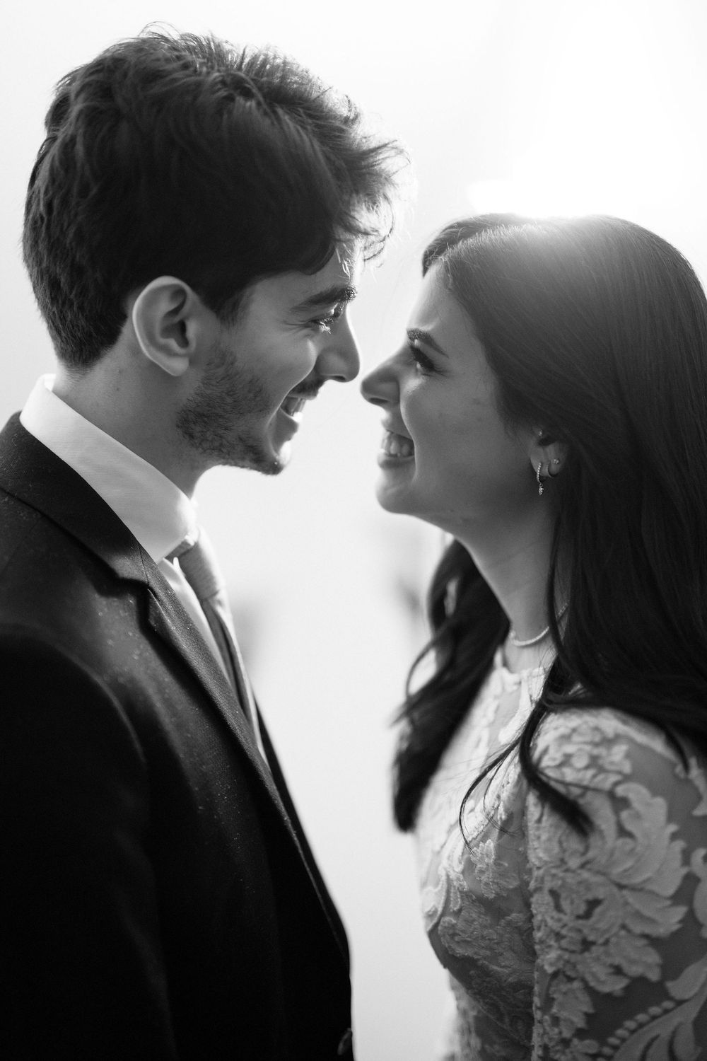 Sequence of romantic black and white portraits showing a couple in formal attire gazing at each other against white background.