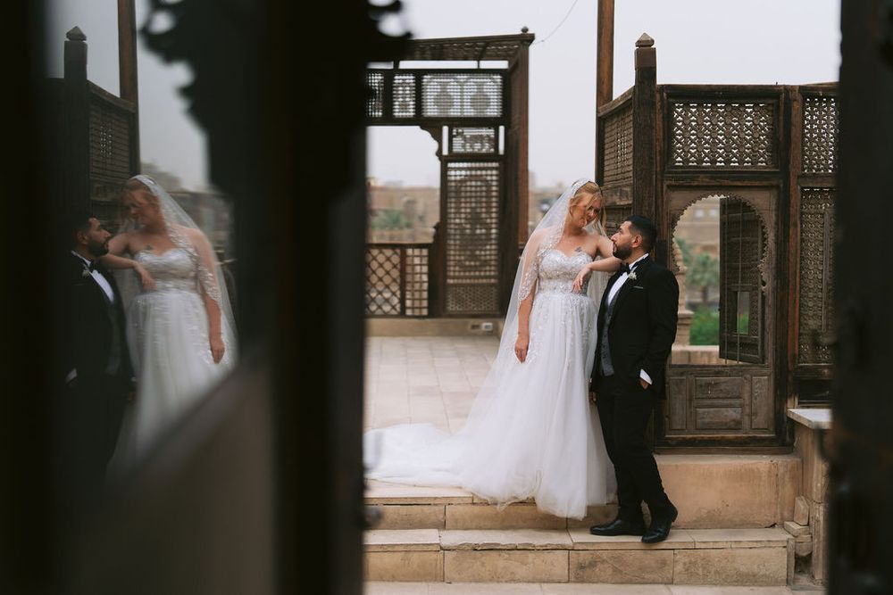 Four elegant wedding photos arranged in a row showing a rustic doorway and couple in formal attire.