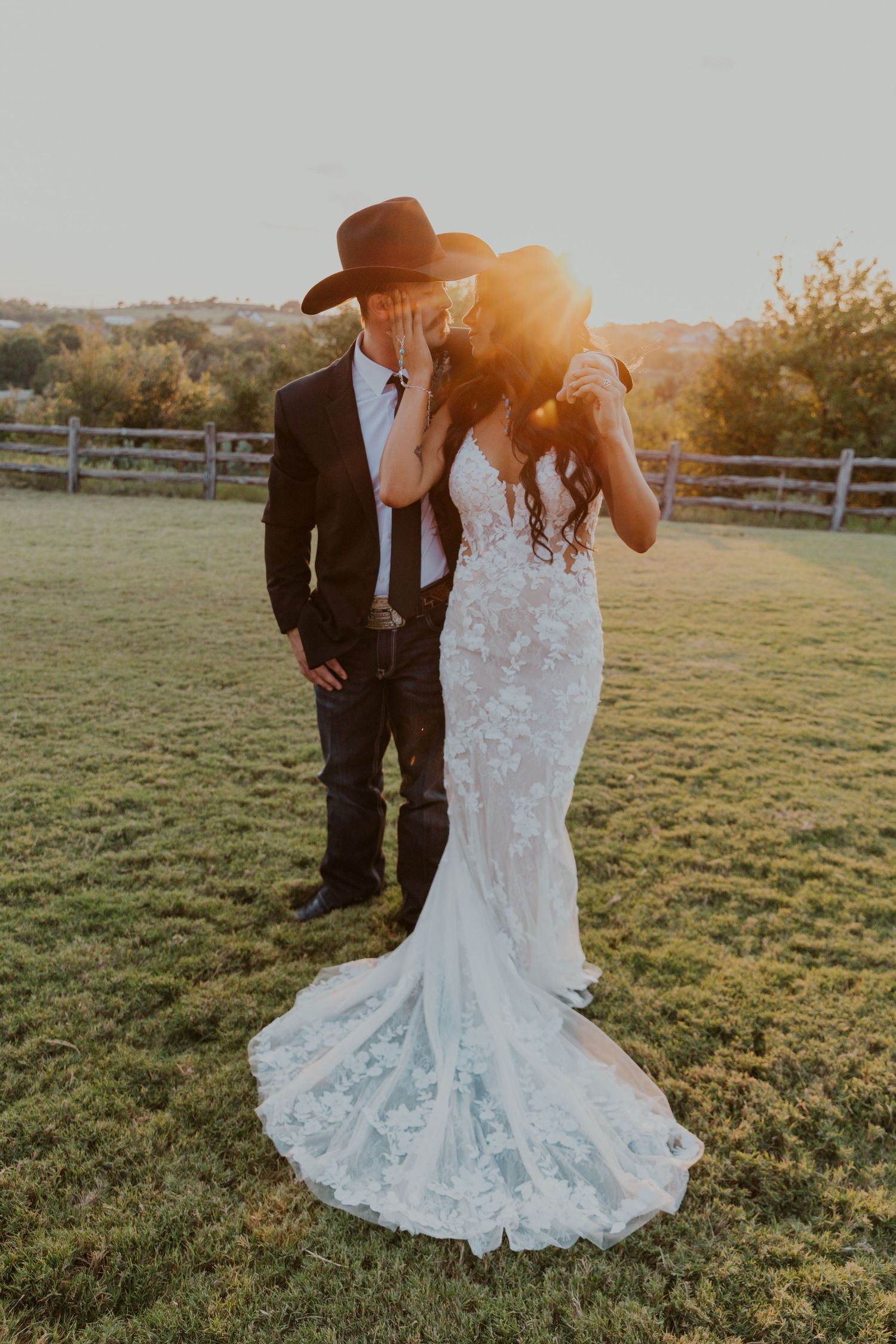Newly weds look at each other while the sun streams between them.