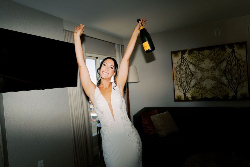 Wedding celebration in a dimly lit room with celebratory champagne.