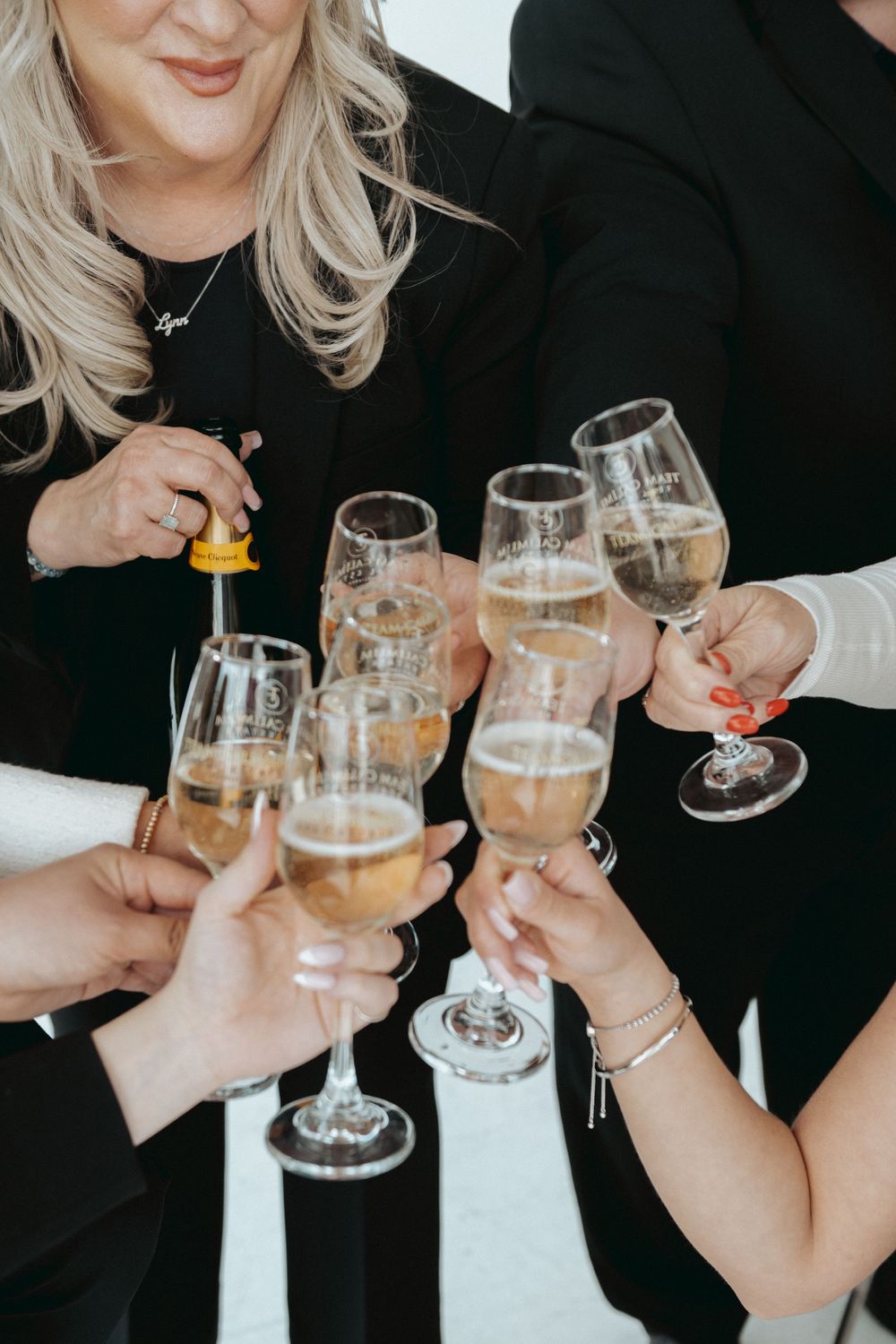 Friends toasting with champagne glasses in a celebratory moment.