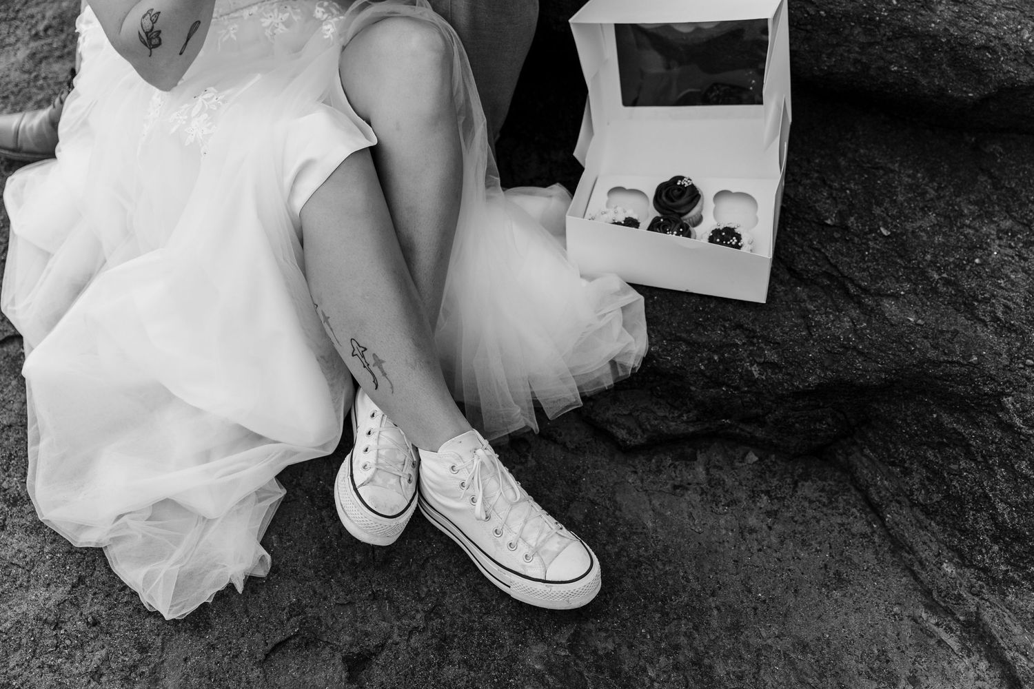 A black and white photo series shows close-up details of shoes, dress fabric, and ring details from a wedding celebration.