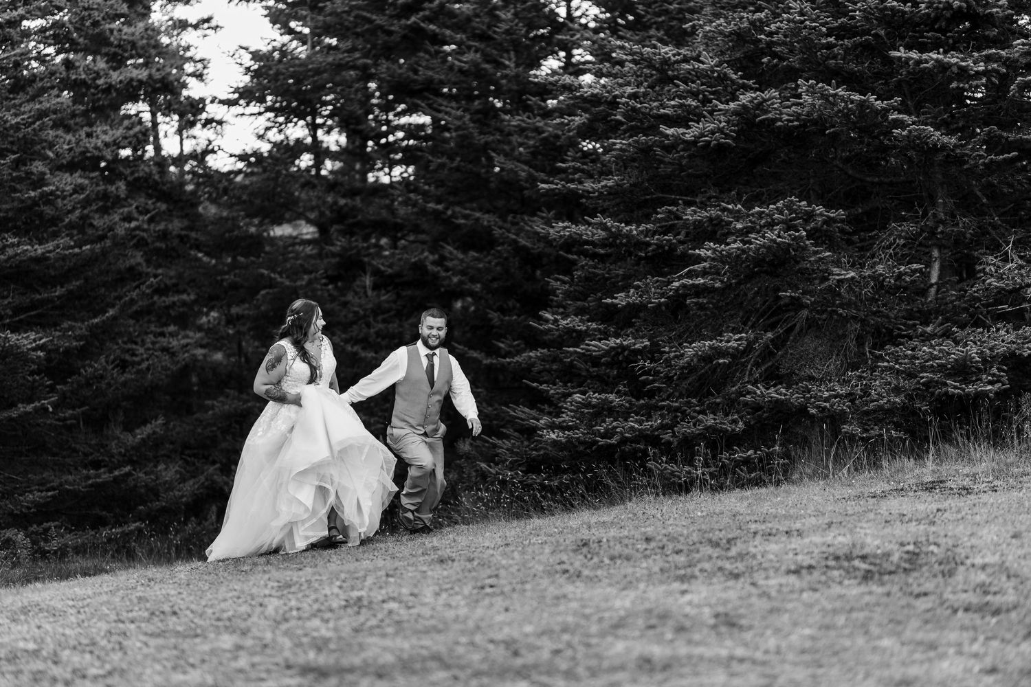 A sequence of black and white photos shows a couple in wedding attire walking and posing together in a wooded setting.