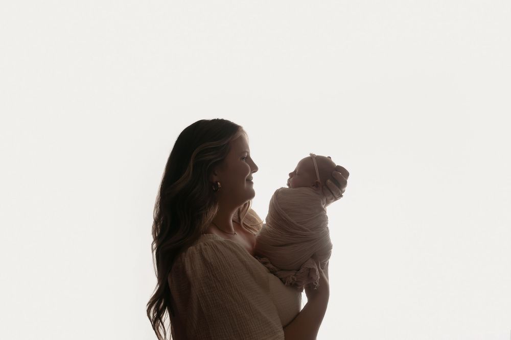Backlit mother and baby pose, taken by Jen Knightstep, Photographer