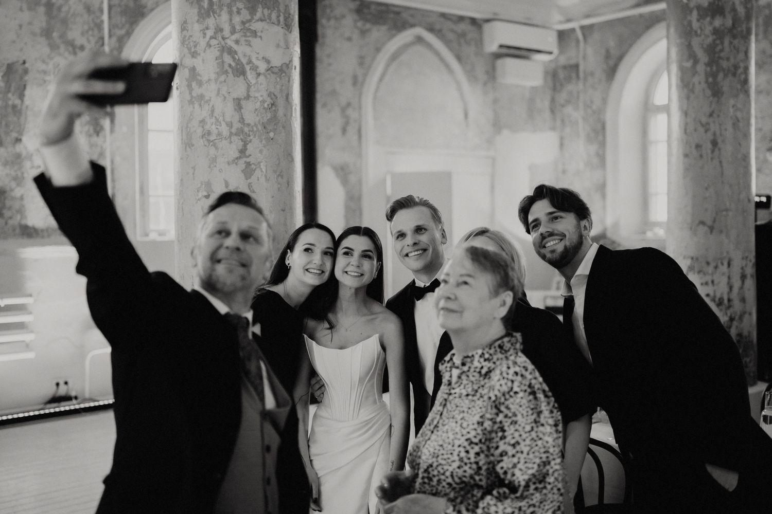 Wedding celebration in a rustic venue with exposed stone walls and elegant decor.