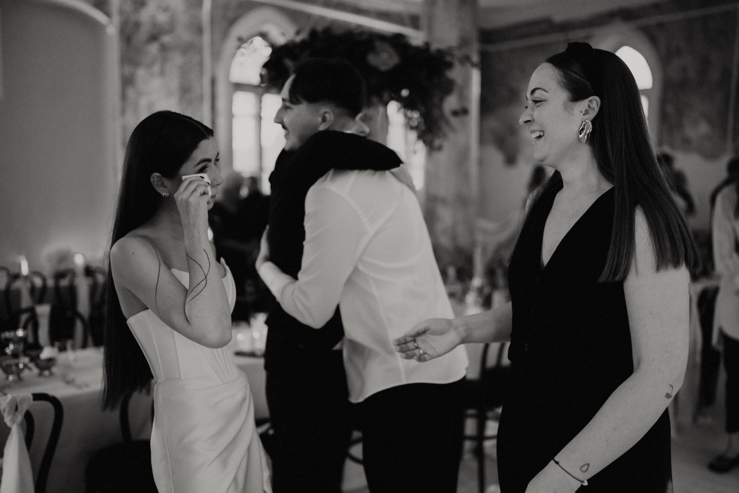 Joyful moments captured during a wedding reception in a historic stone building.