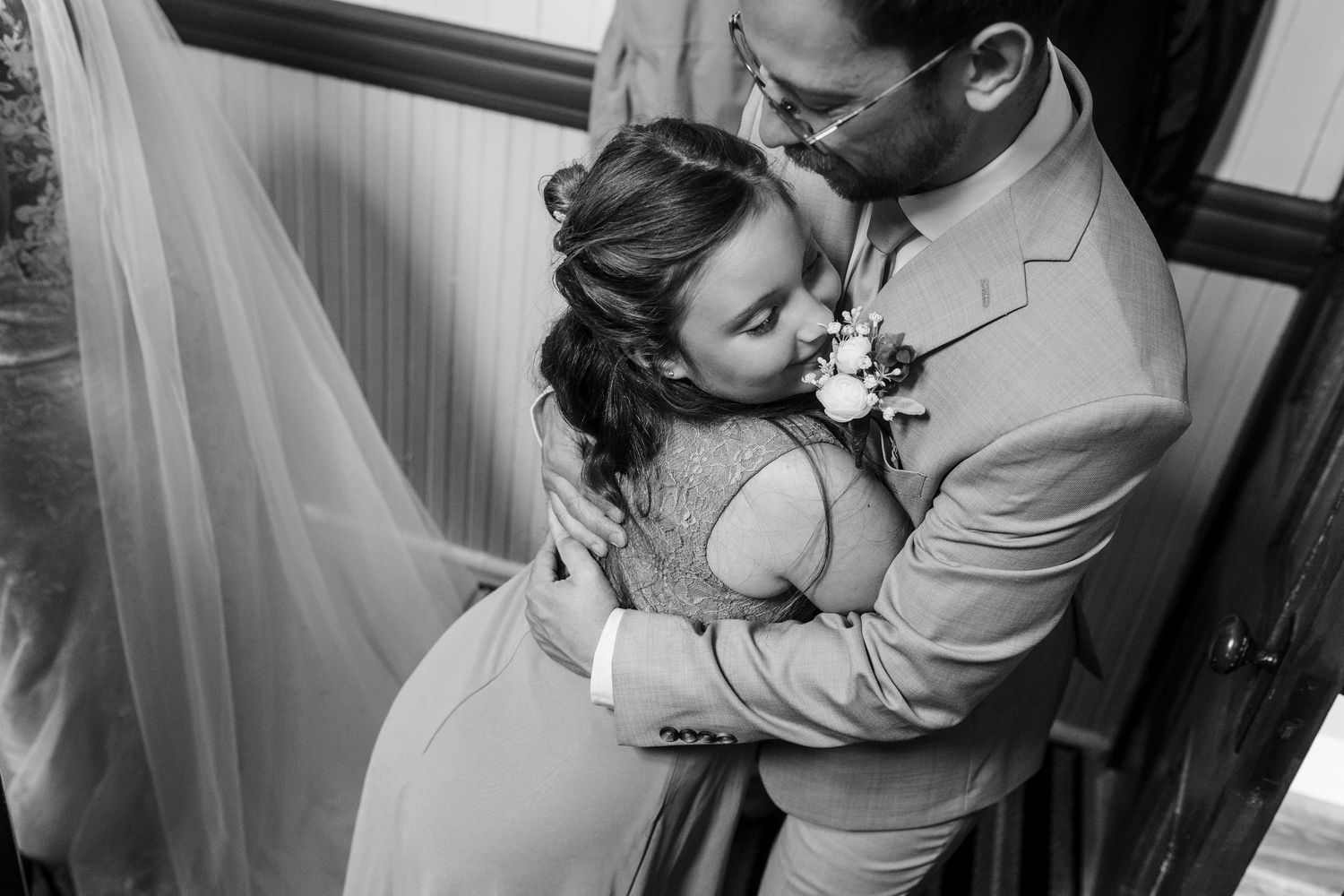 A black and white photo montage showing tender moments between a couple on their wedding day.