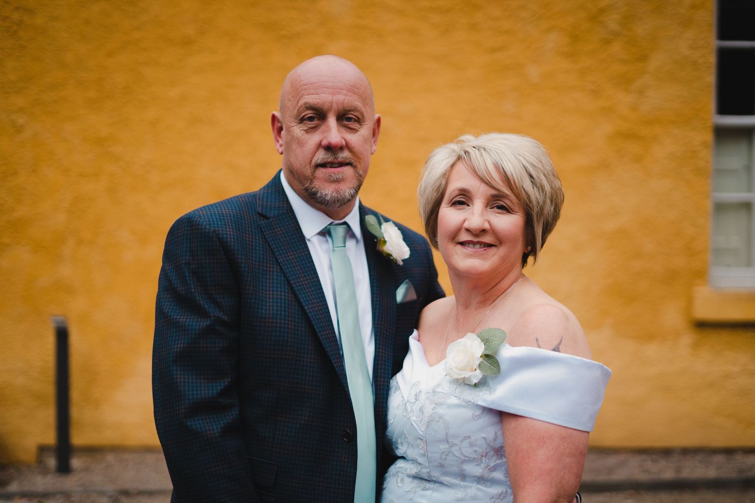 Formal event photo sequence against a vibrant yellow wall capturing celebratory moments.