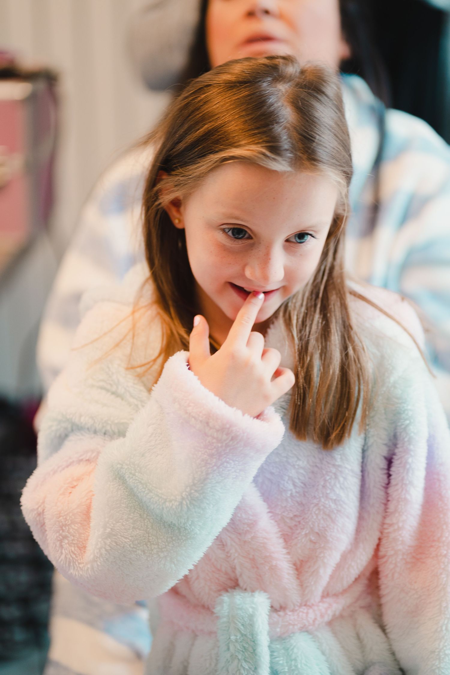 Someone wearing a soft plush robe in pastel colors.