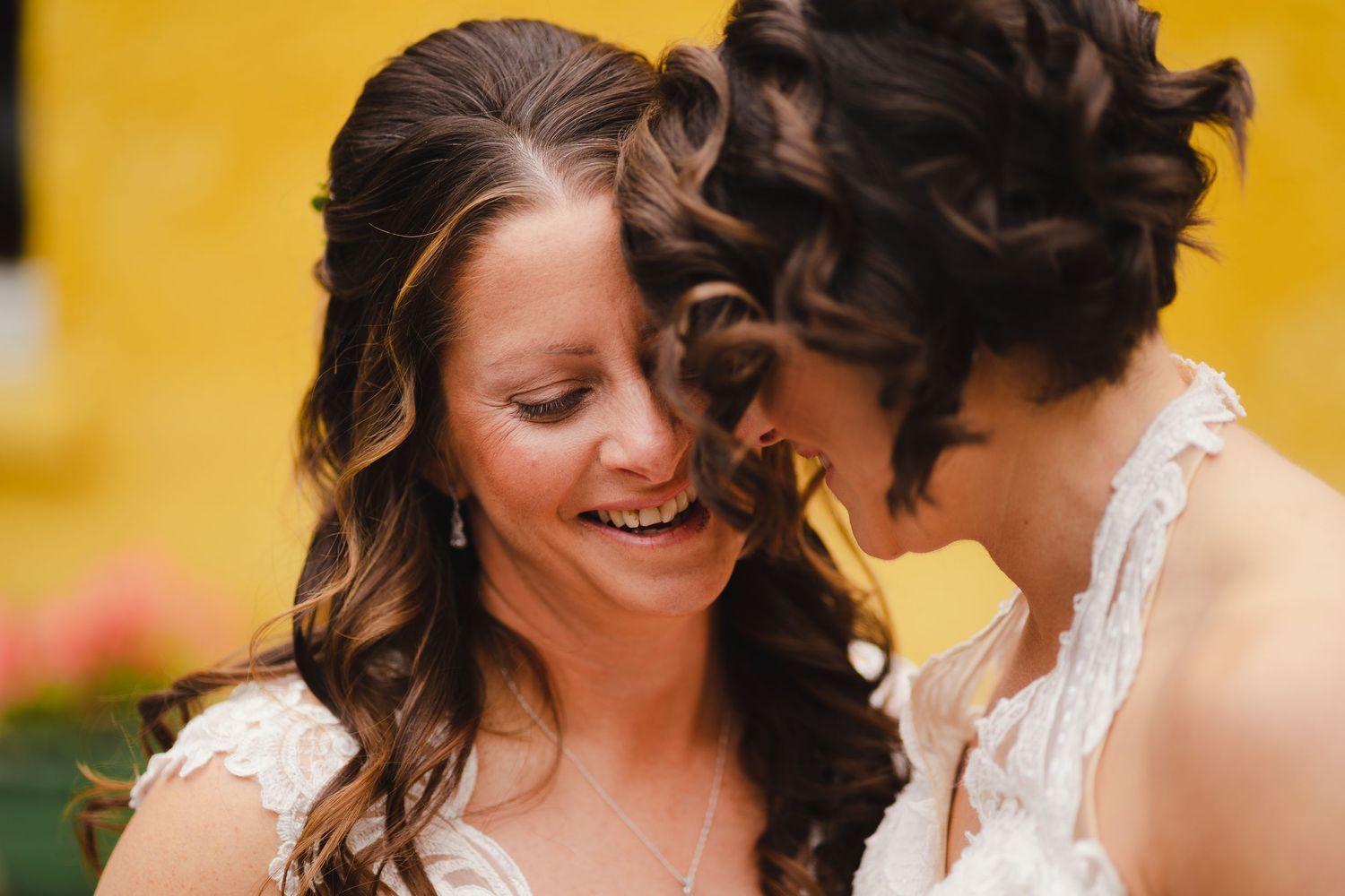 A romantic couple shares an intimate moment in warm golden lighting during an outdoor photo session.