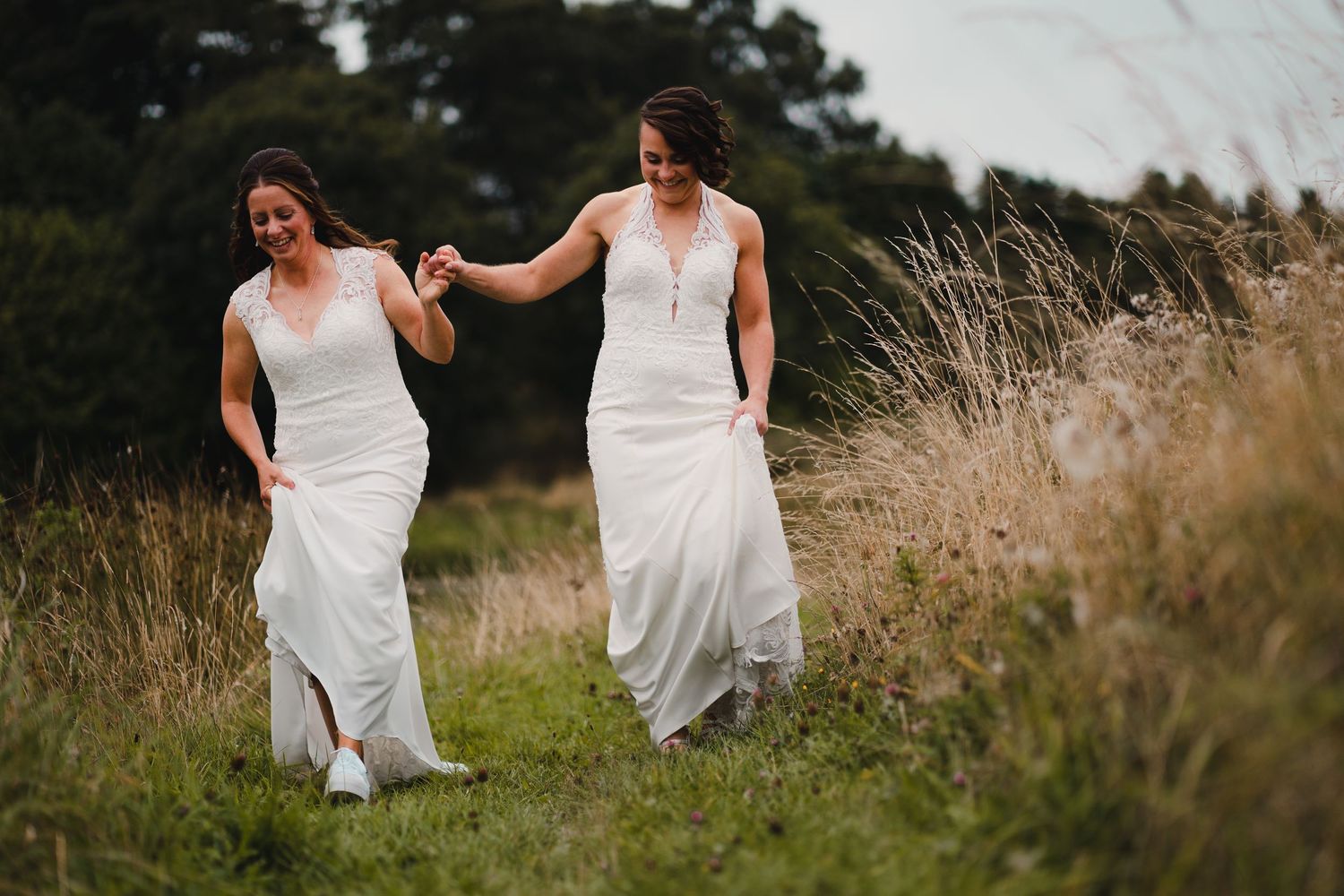 Sequence of artistic wedding photos showing couple walking through tall grass in flowing white dresses at sunset.
