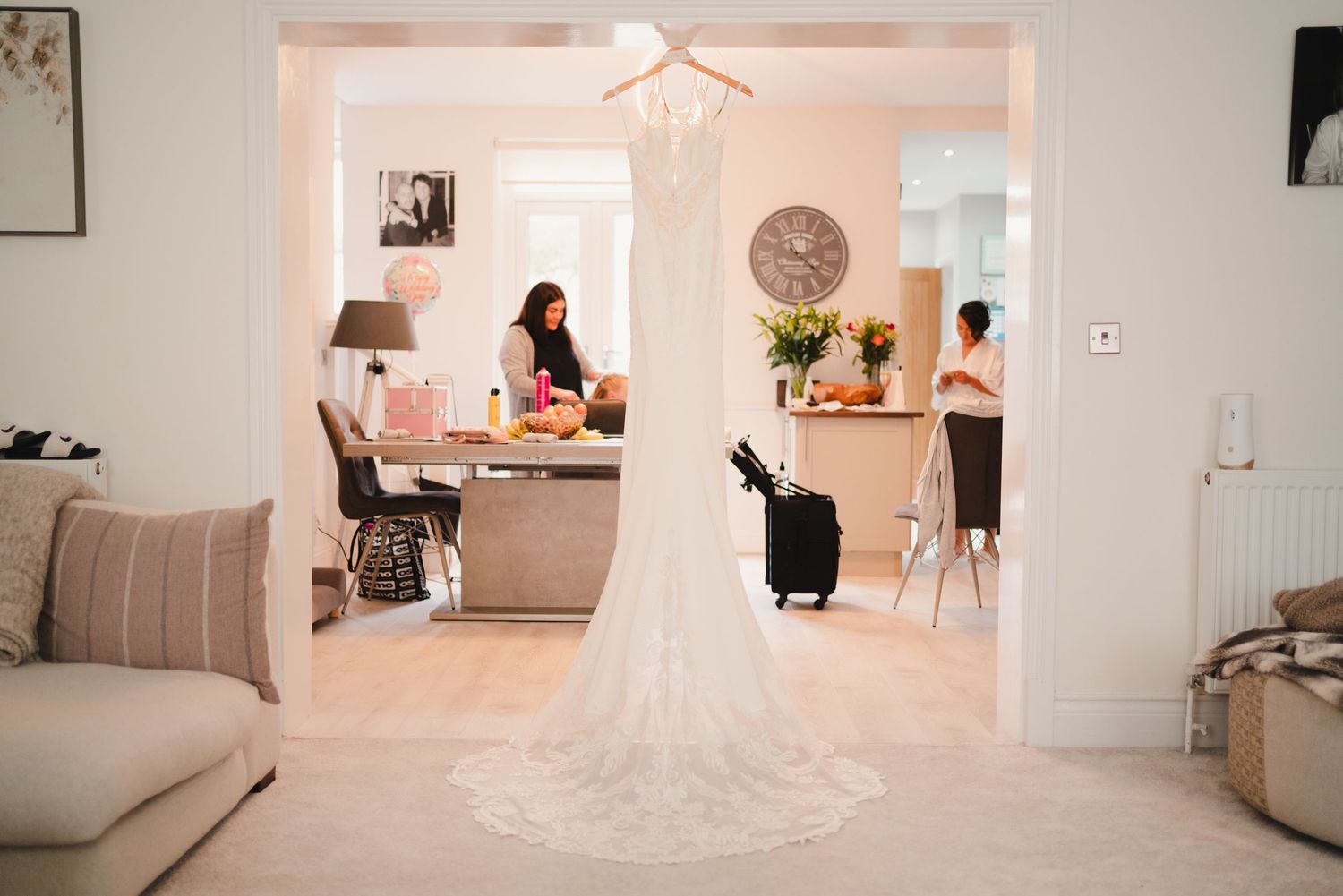 Wedding dress on display in a bright modern home setting with natural lighting.