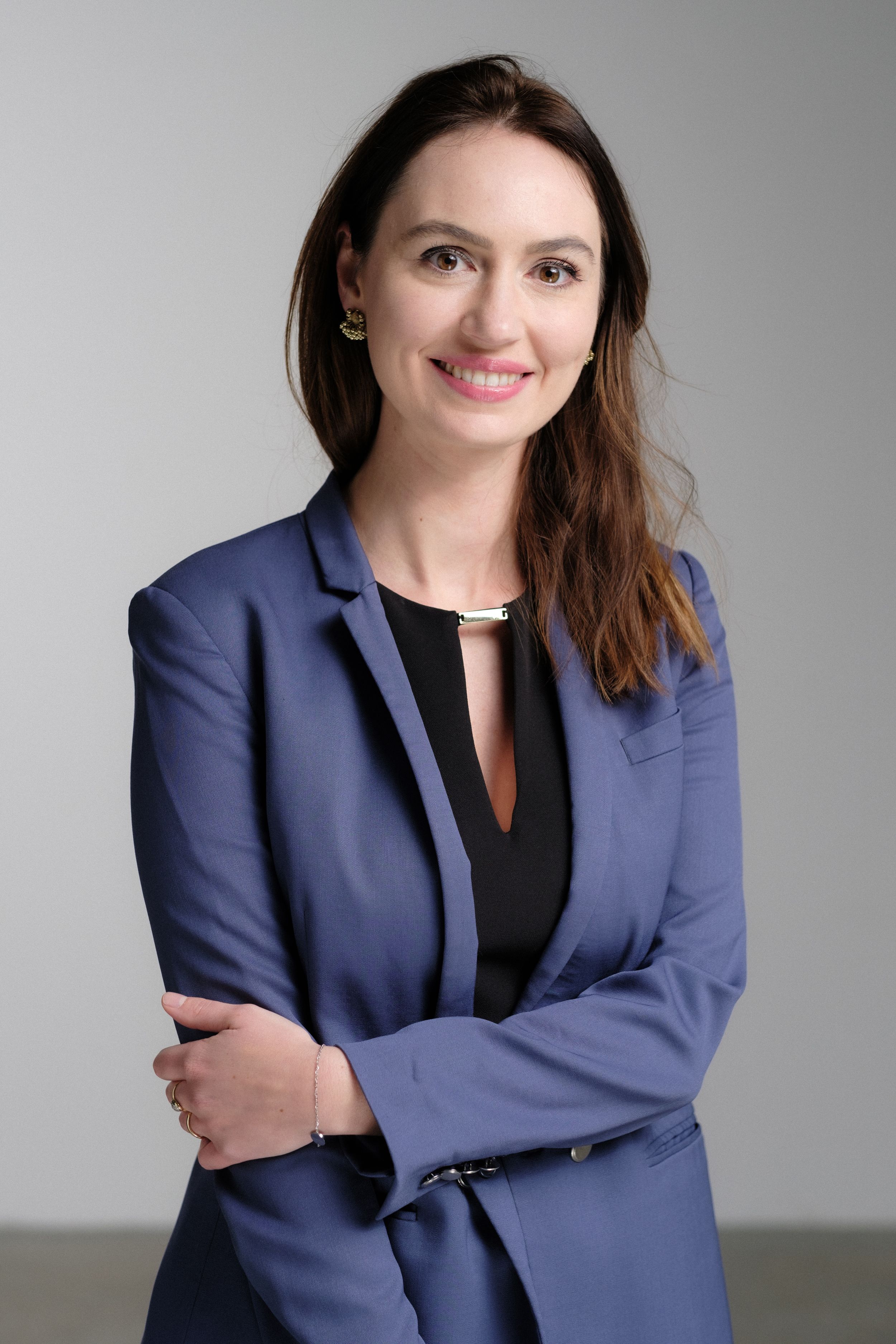 Business portrait series showing professional attire and warm expressions in studio lighting.