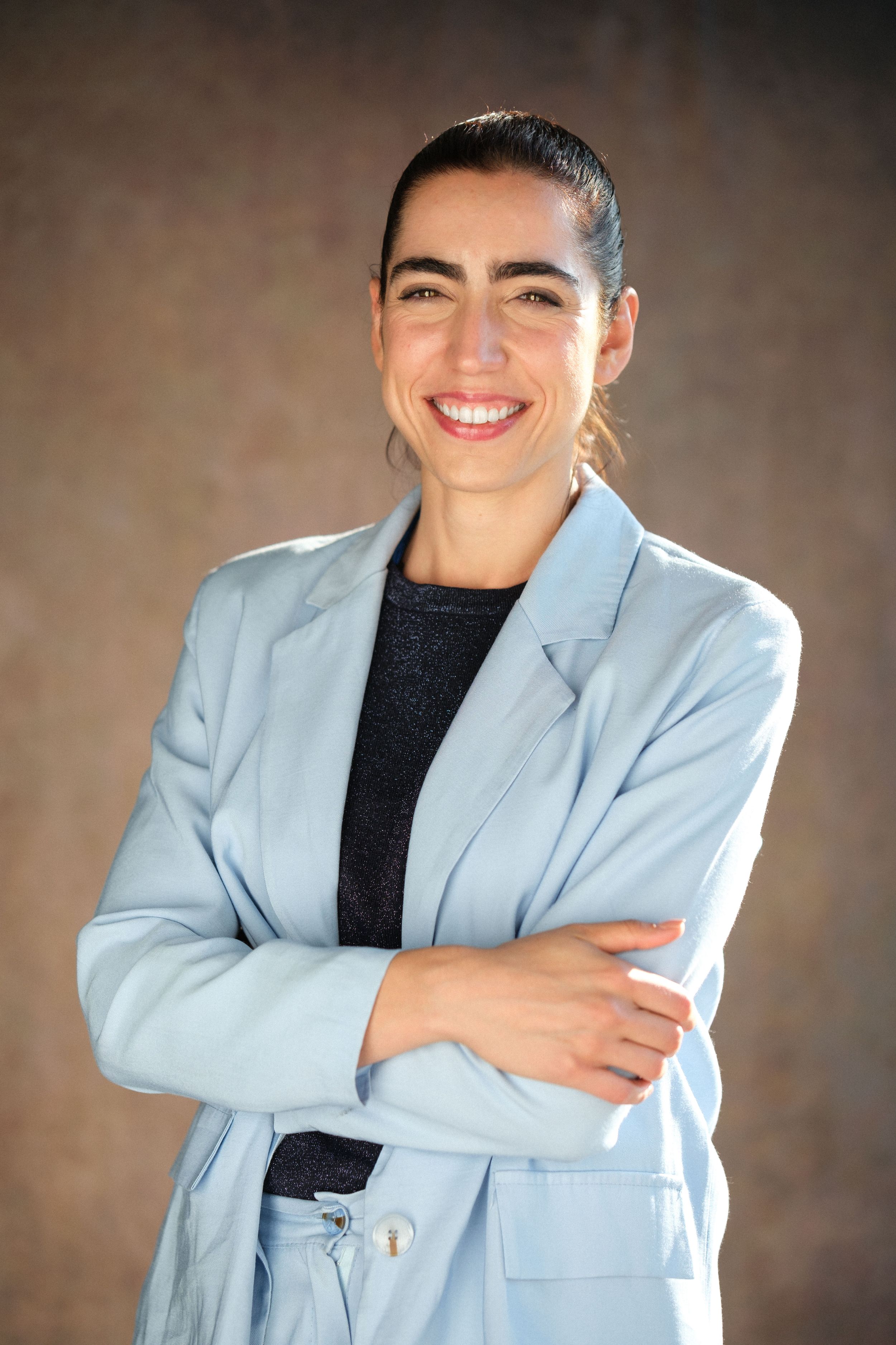 Modern portrait series featuring light blue blazer and black top with confident poses.