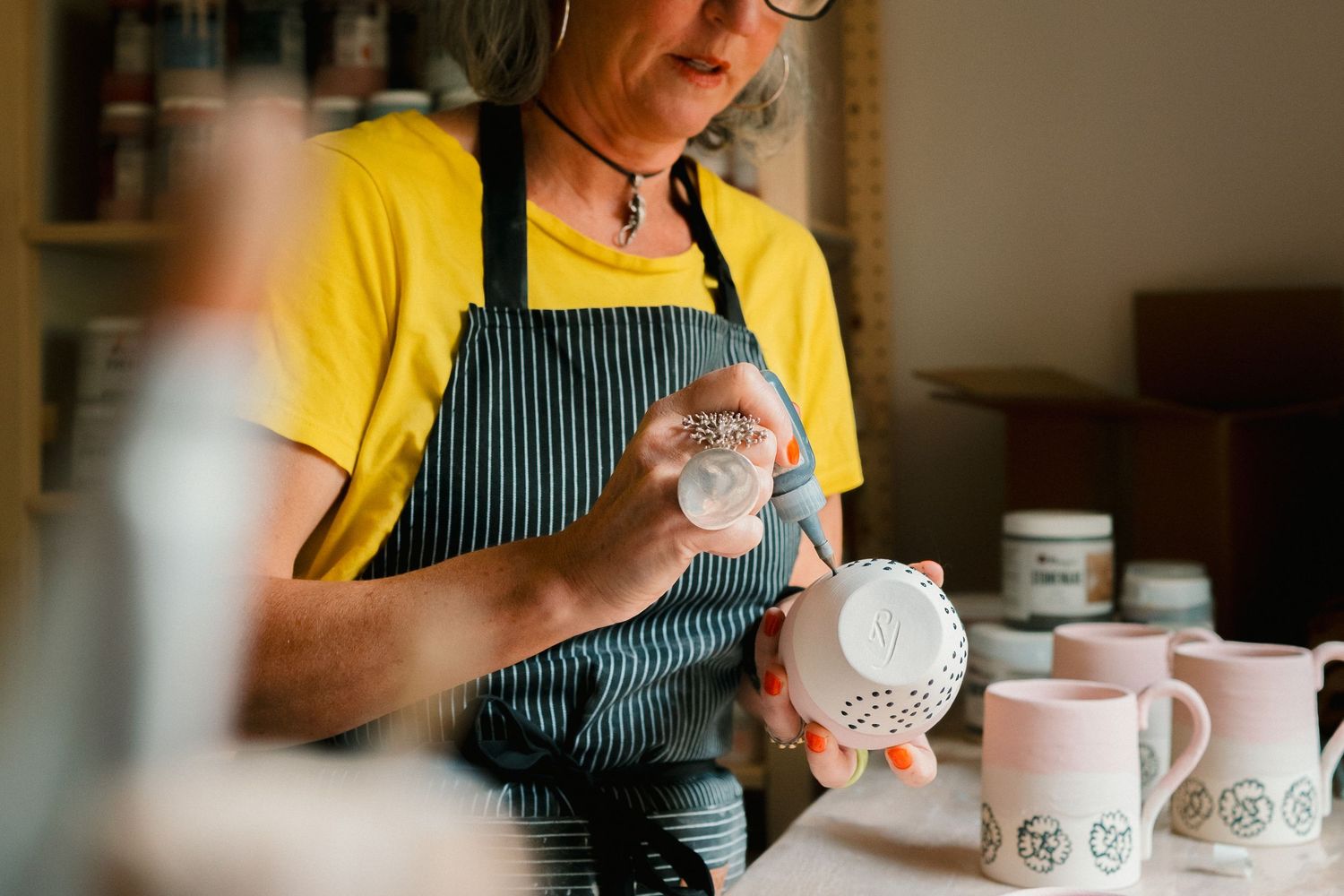 Hands seen arranging coffee cups for a cupping session at a specialty coffee tasting event.
