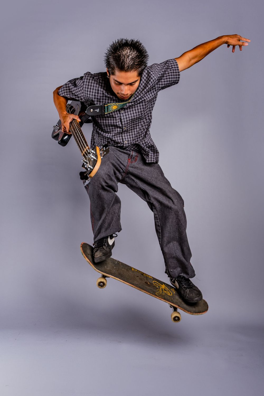 Dynamic sequence of skateboarding tricks performed in grey studio setting.
