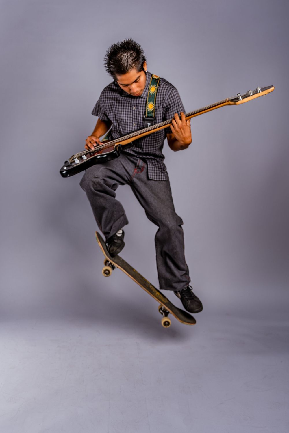 Action shots of skateboarder performing aerial tricks with skateboard in studio.