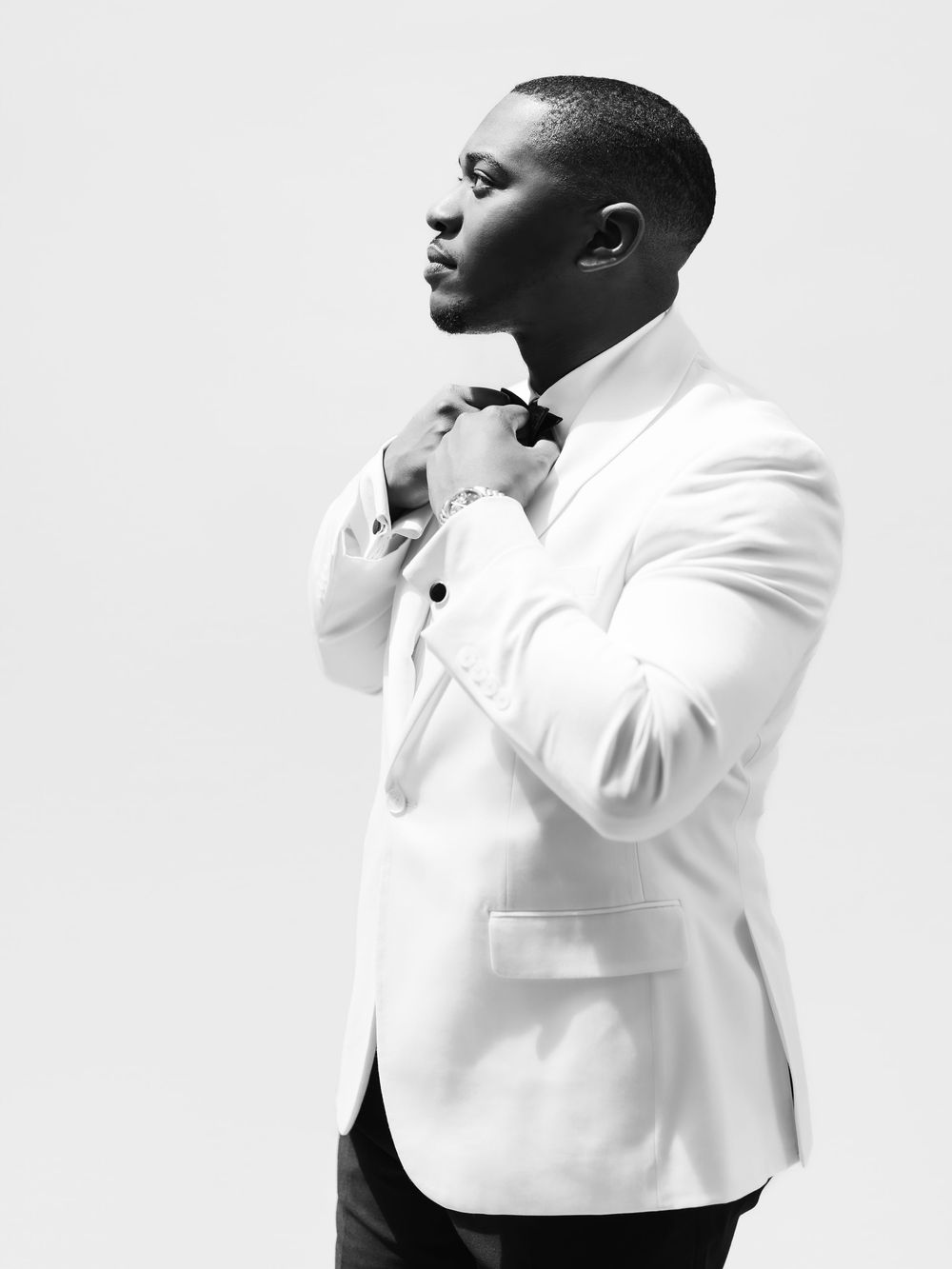 Four views of a person wearing a white turtleneck sweater shown in artistic black and white portrait poses.
