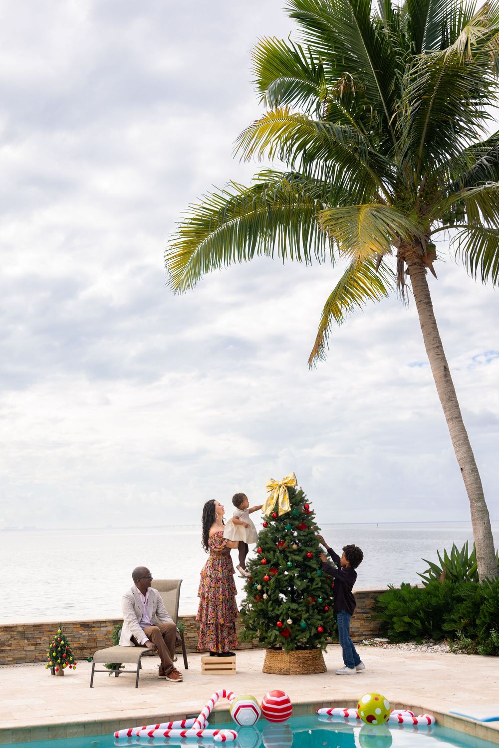 Romantic beach proposal scene with palm trees and ocean backdrop at a tropical destination.