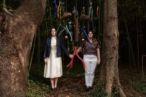 Two brides posing like Wes Anderson