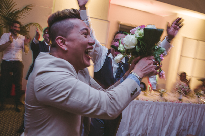 Joyful celebration moment at an indoor event with flowers.