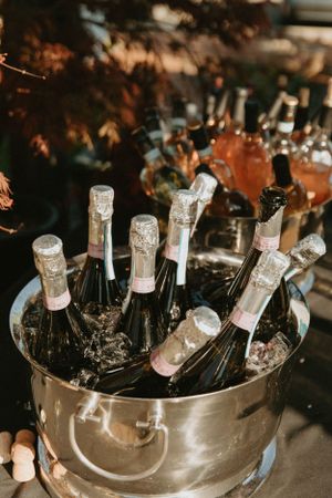 Champagne bottles chilling in silver ice bucket at wedding reception.