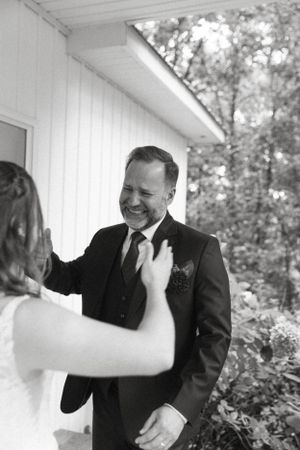 Emotional moment captured in black and white during wedding day.