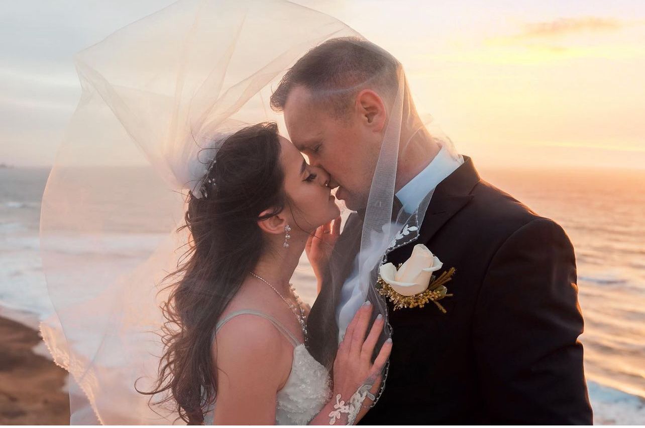 Bay Area wedding photography at sunset on the water with romantic kiss.