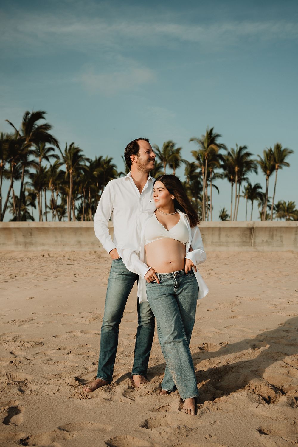 Surrounded by palm trees and sand, celebrating their baby bump on the beaches of Mazatlán