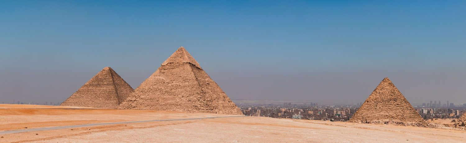 Panoramavy över pyramiderna i Giza under en klar blå himmel