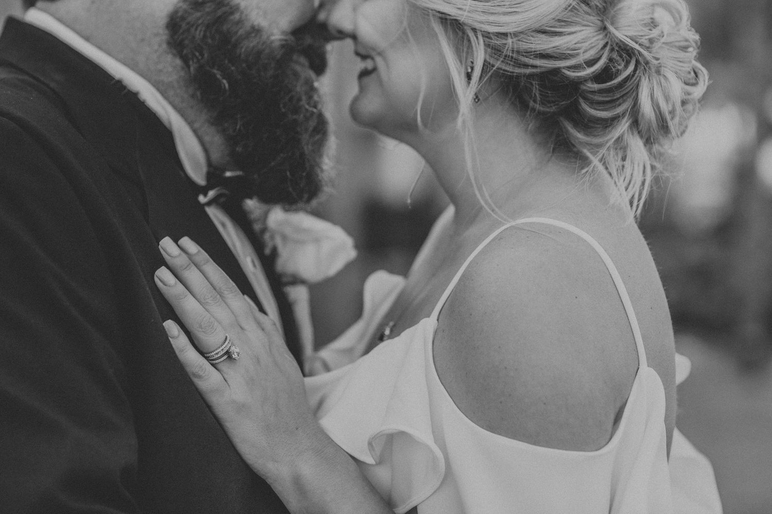 An intimate black and white photo capturing a tender wedding moment.