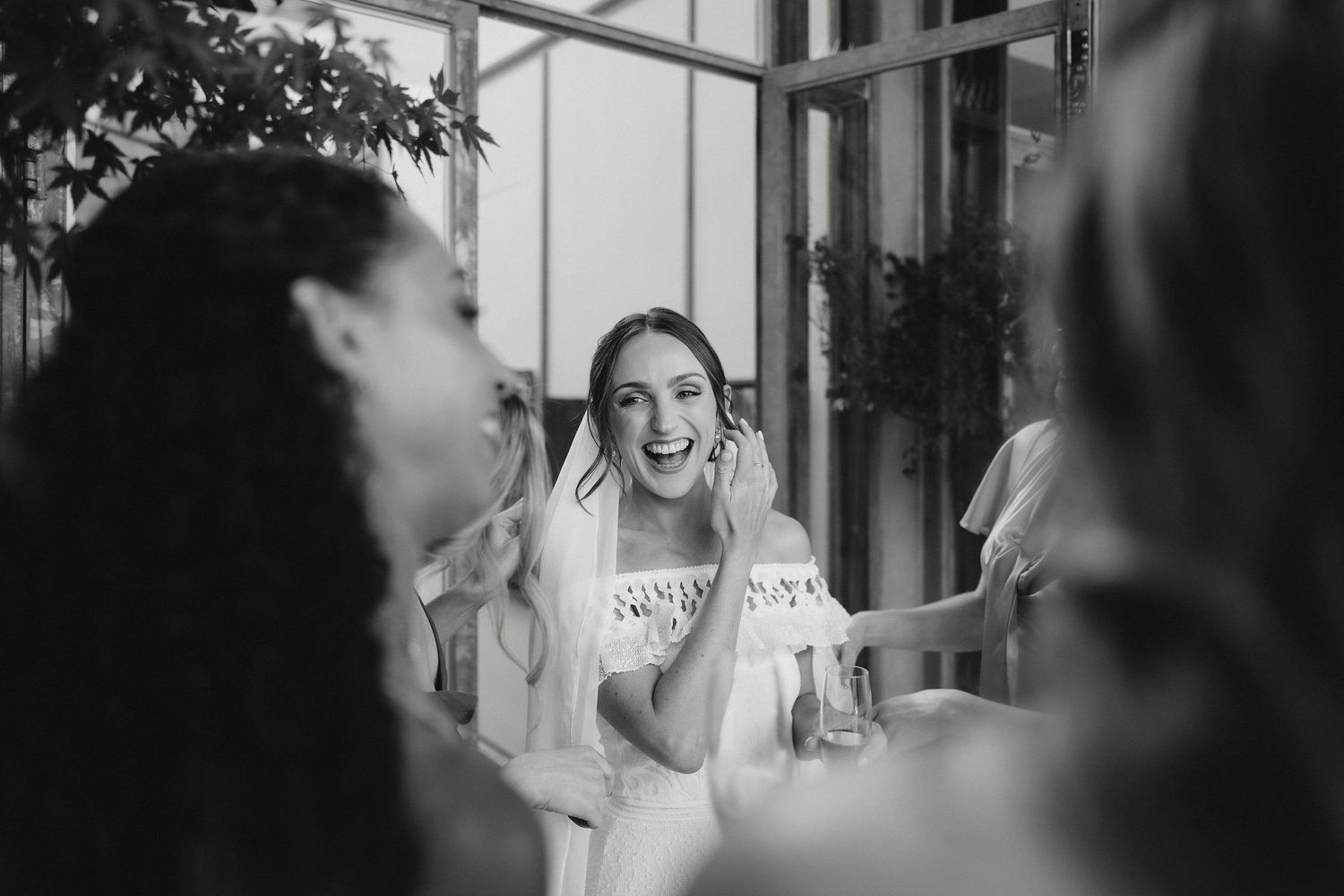 A candid black and white photo captures a joyful moment during a celebration with friends.