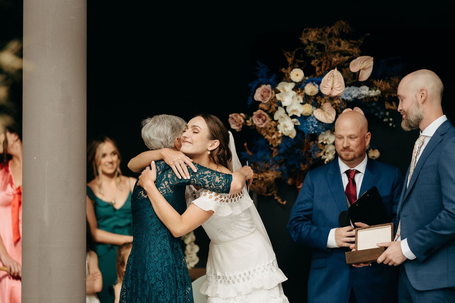 A joyful wedding celebration moment shared between a bride and guests during an outdoor reception.