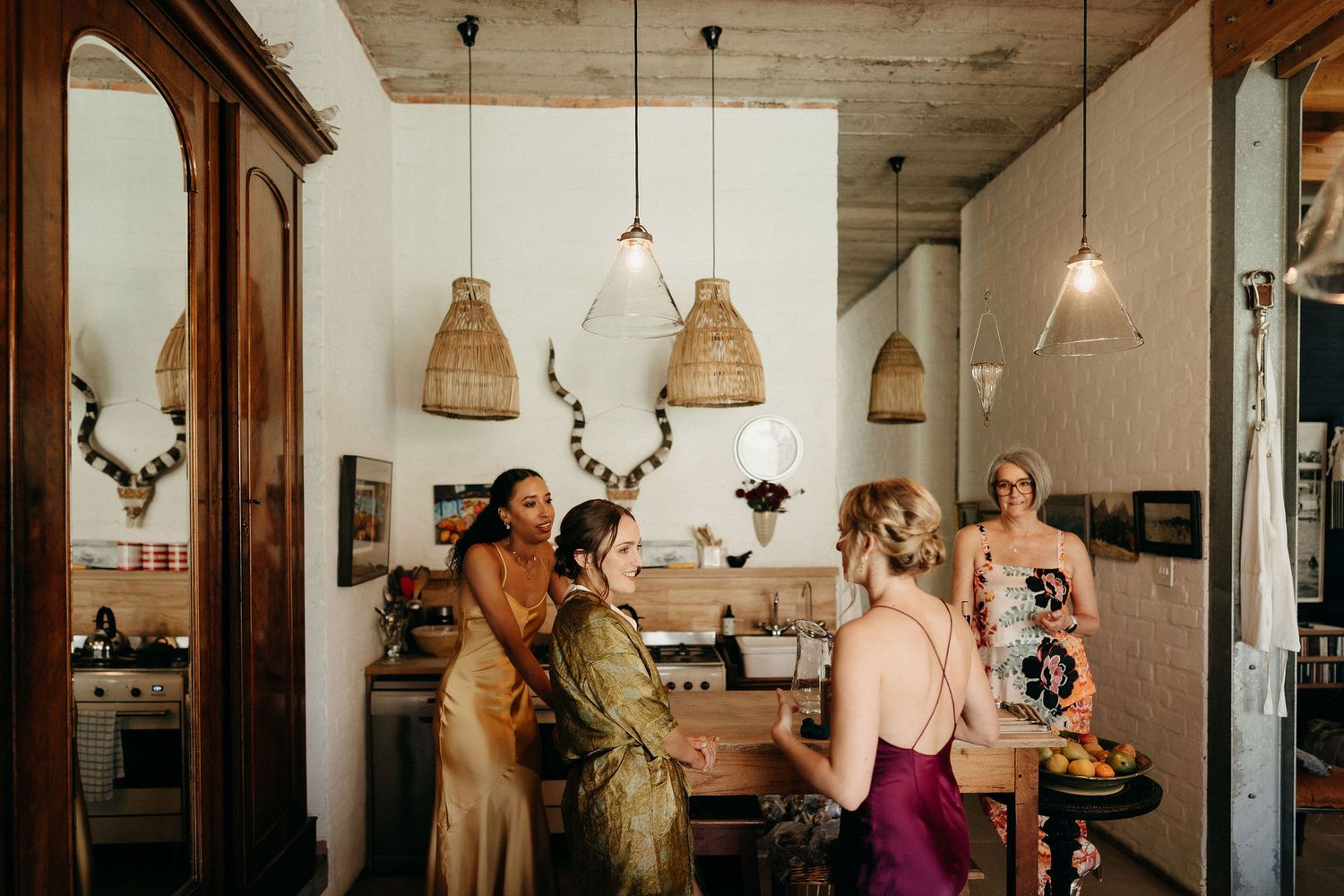 Stylish cafe interior with pendant rattan lamps and people chatting at counter under warm lighting.