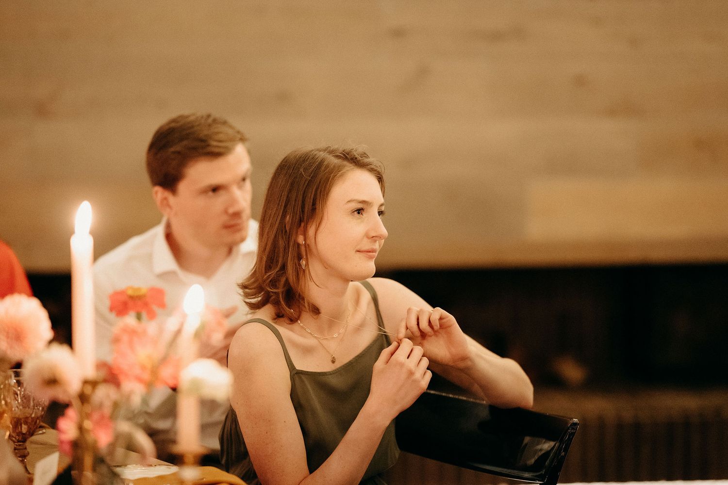 A warm candlelit dinner scene with romantic lighting and floral table decorations.
