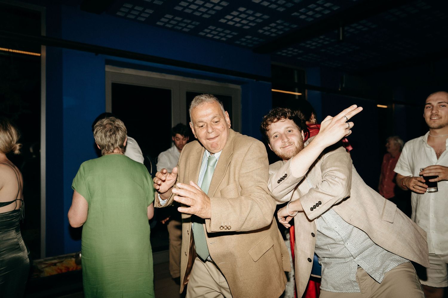 People dancing and socializing at what appears to be a party or nightclub gathering.