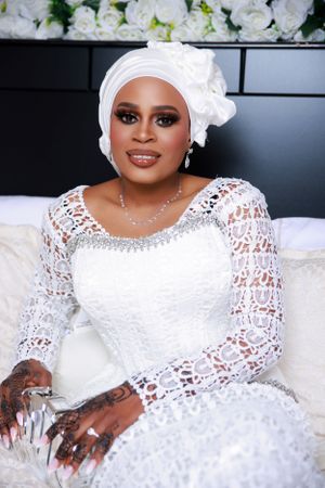 Wedding fashion shoot featuring white lace gown and traditional head covering.
