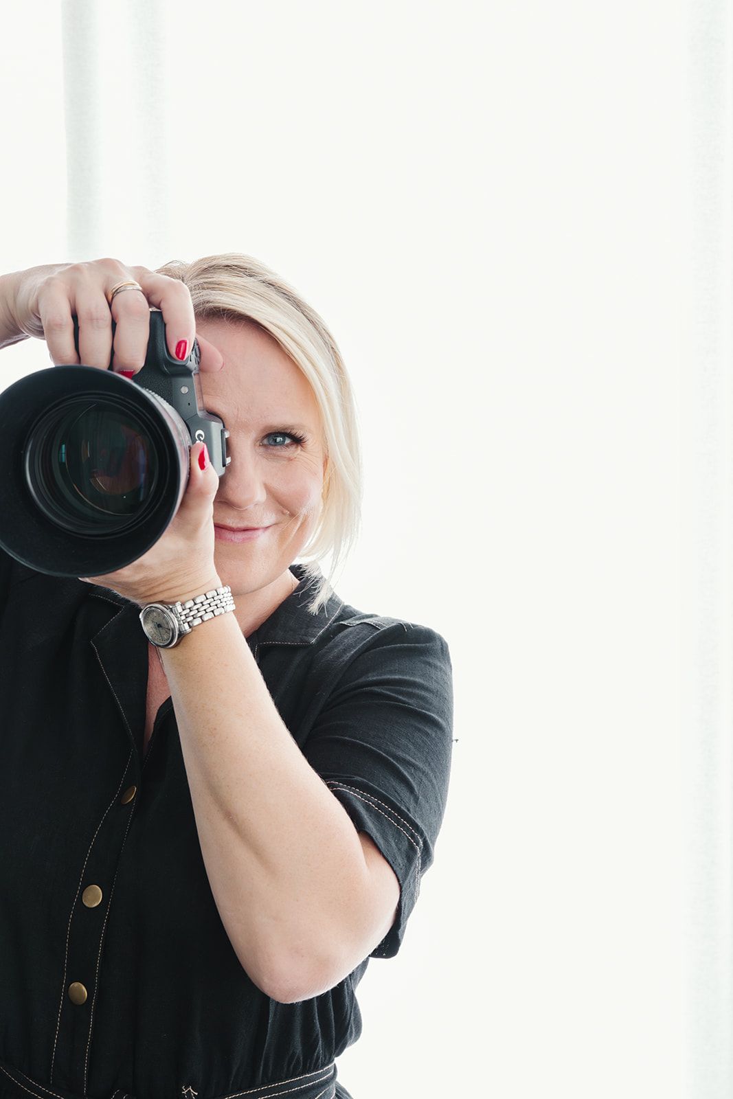 CEO holding a camera ready to do a photoshoot