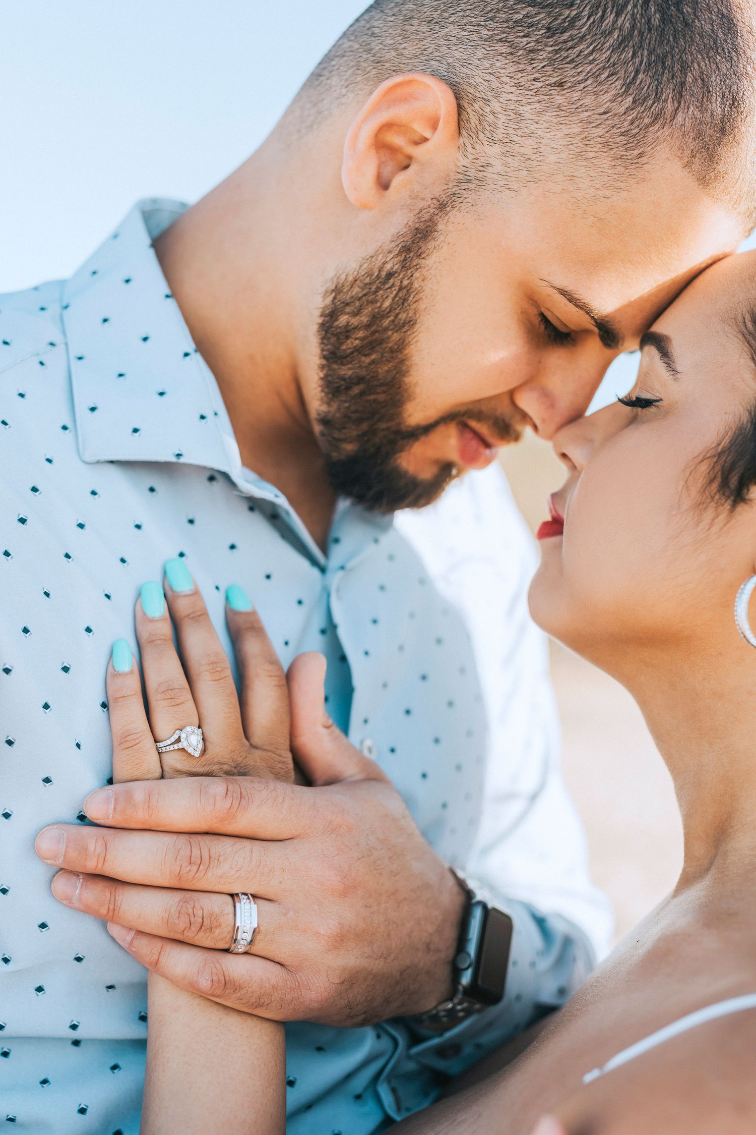 Close-up engagement photos showing tender moments and diamond ring details.